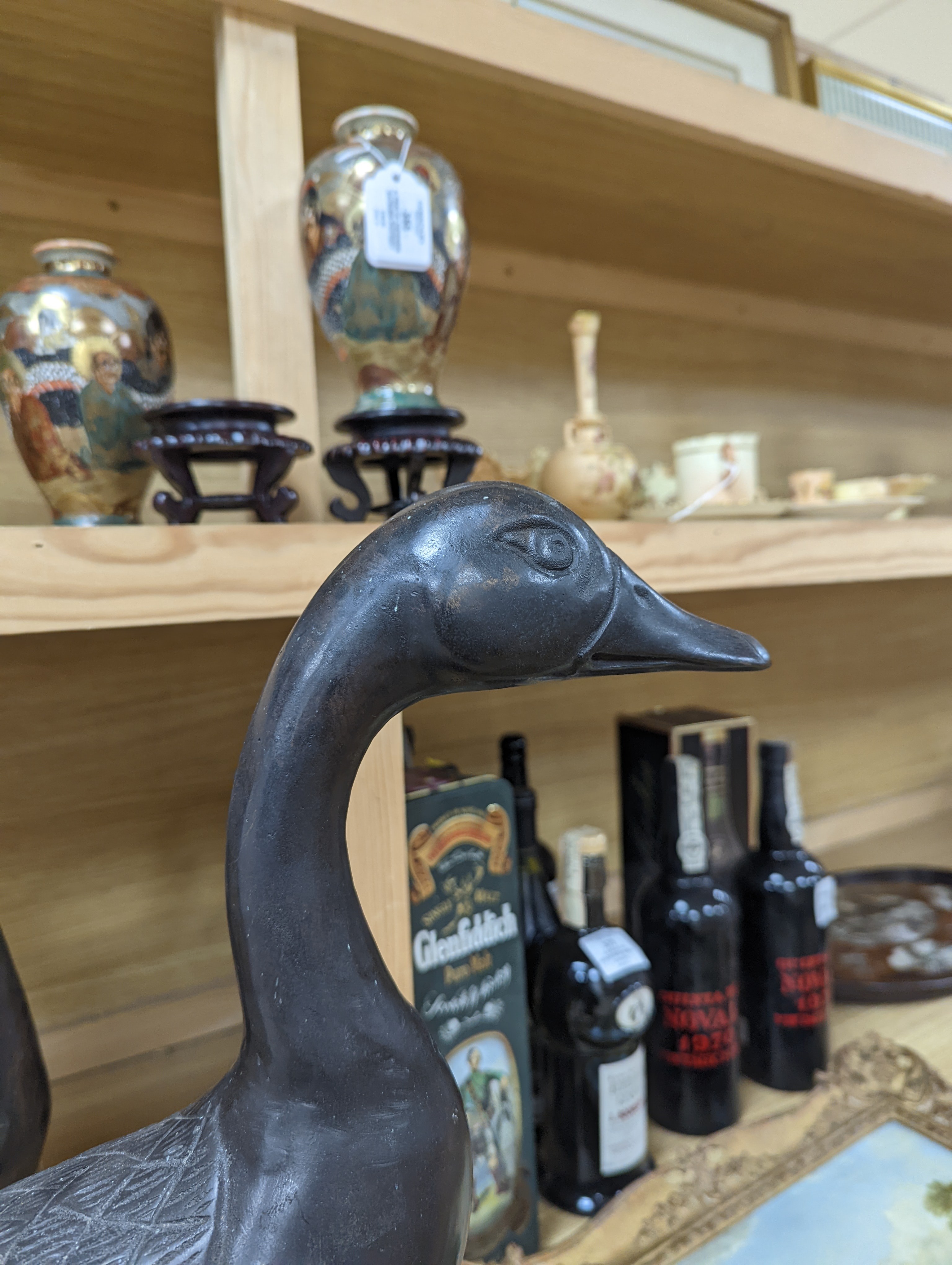 A pair of modern Chinese bronze models of geese, largest 48cm
